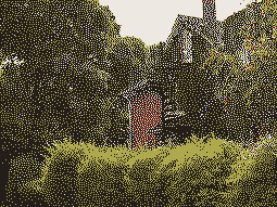 The side of a vine-covered house with a spiral staircase, obscured by vegetation, rendered in low resolution with dark, light, orange, and green dots.